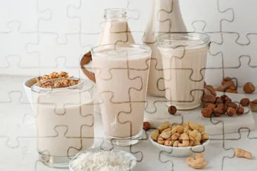 Assortment of tasty vegan milk on light table jigsaw puzzle