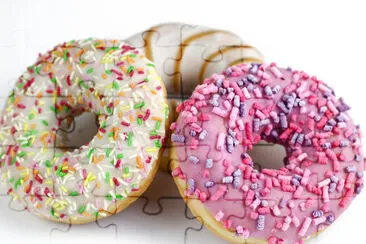 Colorful tasty donut on a white background. Green, jigsaw puzzle