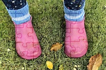 Pink boots in autumn garden