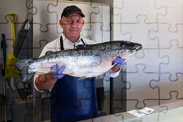 Fish Monger Holding a Salmon