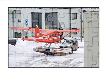 Half truck moving a small plane