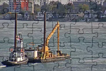 tug Capt Keith pushing a Spud-Barge with excavator